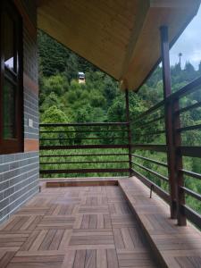 a balcony of a house with a view at Cabin in the Woods in Vashisht