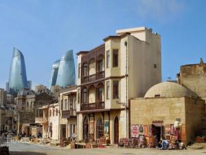 a group of buildings on a city street with tall buildings at Pera Hotel Baku in Baku