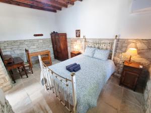 a bedroom with a bed with a blue suitcase on it at Athena's Pool Oasis in Skarinou