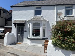 a white house with a window and a door at 2 Edward Street in Llandudno