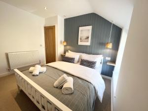 a bedroom with a large bed with towels on it at 2 Edward Street in Llandudno