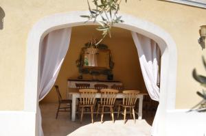 un comedor con un arco con mesa y sillas en Villa SULIS en Lorgues