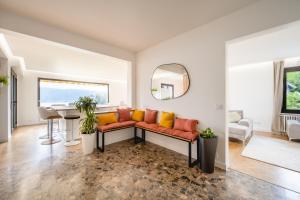 a living room with a couch and a table at La Villa Manali in Veyrier-du-Lac