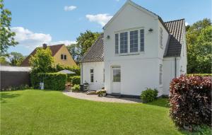 a white house with a yard at Beautiful Home In Idestrup With Wifi And 3 Bedrooms in Idestrup