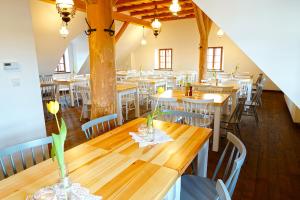 een restaurant met houten tafels en stoelen in een kamer bij Browar POD CZARNYM KOGUTEM in Cieszyn