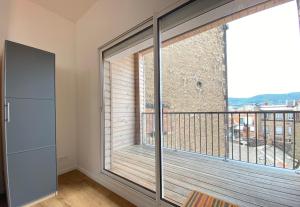 a large window in a room with a balcony at Tour d'Auvergne - Appartements en plein centre ville, proche de la cathédrale et de la place de Jaude in Clermont-Ferrand