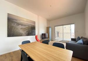 a living room with a table and a couch at Tour d'Auvergne - Appartements en plein centre ville, proche de la cathédrale et de la place de Jaude in Clermont-Ferrand