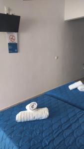 two towels on a bed in a room at Elzahed apartments bonaccia in Kimolos