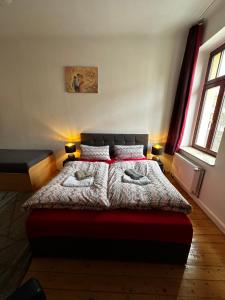a bedroom with a bed with two pillows on it at Art-Haus-Leipzig in Leipzig