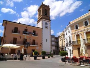 a building with a clock tower in the middle of a street at ROMI ORBA in Orba