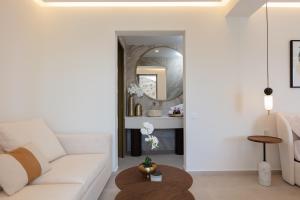 a living room with a white couch and a mirror at Naiades Boutique Hotel - Adults Only in Elounda +60 photos