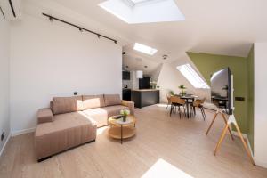 a living room with a couch and a table at New flat with free underground parking and air conditioning in Rīga