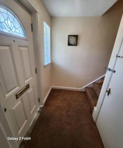 an empty hallway with a door and a window at Cozy 1 Bedroom Business Suite in Philadelphia