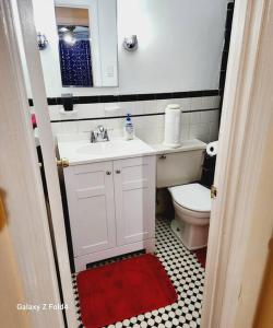 a small bathroom with a sink and a toilet at Cozy 1 Bedroom Business Suite in Philadelphia