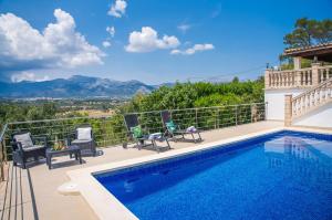 a villa with a swimming pool and mountains in the background at Ideal Property Mallorca - Es Claperas in Inca