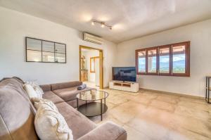 a living room with a couch and a tv at Ideal Property Mallorca - Es Claperas in Inca