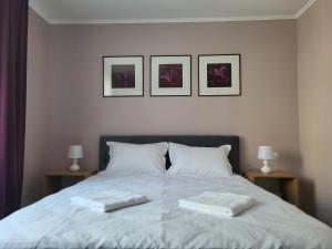 a bedroom with a bed with two towels on it at Pandora Central Apartment in Cluj-Napoca