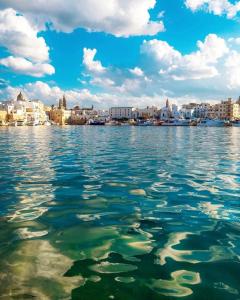 a view of the water with a city in the background at Donna Nina in Monopoli