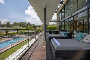 a balcony with two beds and a swimming pool at Villa Calypso in Mouans-Sartoux