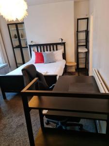 a bedroom with a bed and a desk and a piano at Lovely One bedroom Aprt in central London in London