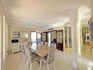 a kitchen and dining room with a table and chairs at Luxury Villa Lucia in La Playa de Tauro