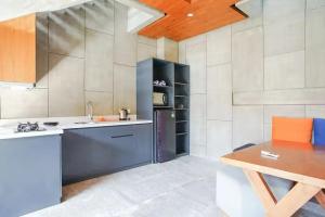 a kitchen with a counter and a table in a room at Aqilah Villa Bali in Legian