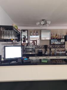 a bar with a counter with a computer on it at THE GREENHOUSE 