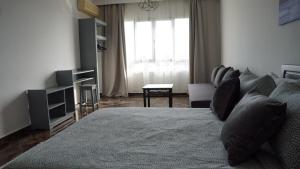 a bedroom with a bed and a living room at hotel azayla in Asilah