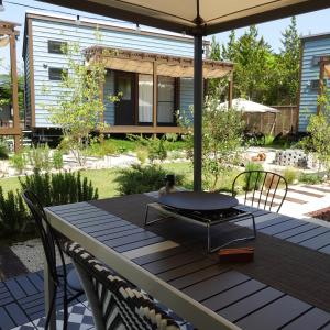 a table with chairs and an umbrella on a patio at R Garden in Yamanakako