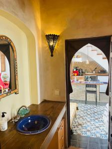 a bathroom with a blue sink in a room at Casa Patio de Monjas in Vejer de la Frontera