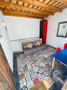 a living room with a floor covered in tiles at Casa Patio de Monjas in Vejer de la Frontera