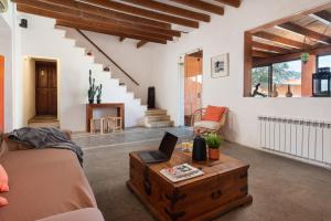 a living room with a couch and a table with a laptop at Sunset Villa Can Calco in Moscari