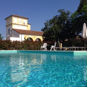 una piscina frente a un edificio con una torre de reloj en Residence Cà Beregana, en Vicenza