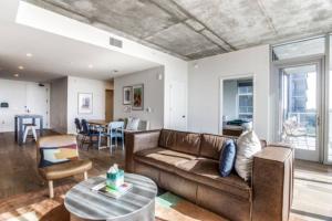 a living room with a couch and a table at 2 BR Lux Panoramic View - Rainey in Austin