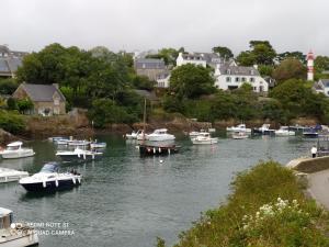 a group of boats are docked in a harbor at Au coeur des Rias, studio Merrien proche de la mer in Moëlan-sur-Mer