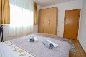 a bedroom with a bed with towels on it at Apartment Hercegovina in Mostar