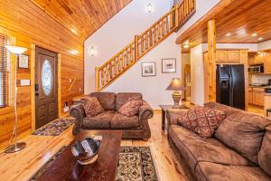 a living room with two couches and a table at Donovans Dacha in McHenry