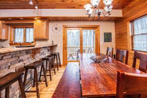 a kitchen and dining room with a table and chairs at Donovans Dacha in McHenry