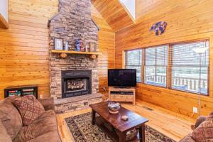 a living room with a fireplace and a tv at Donovans Dacha in McHenry