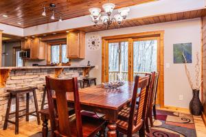 a kitchen and dining room with a wooden table and chairs at Donovans Dacha in McHenry