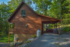 a log cabin in the woods with a porch at Hidden Treasure in Oakland