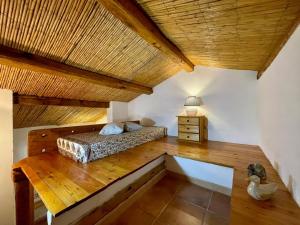 ポルト・ロトンドにあるDomo s'Alturaの木製の天井が特徴のベッドルーム1室(ベッド1台付)