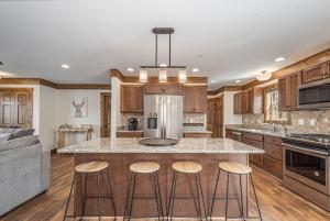 a kitchen with a large island with bar stools at Happy Ours in McHenry