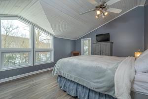 a bedroom with a bed and a ceiling fan at Lake Life HQ in McHenry