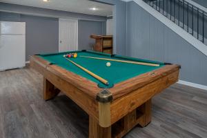 a pool table in a living room with a pool at Lake Life HQ in McHenry