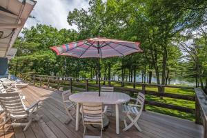 a table and chairs on a deck with an umbrella at Just Around the Dilly in Swanton