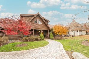 a house with a brick driveway in front of it at Happyplace Hideaway in McHenry