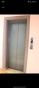 a large glass elevator door in a building at Attic place South B. in Nairobi