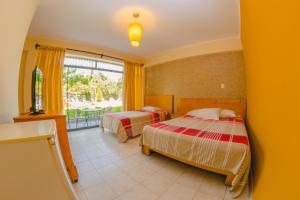Postel nebo postele na pokoji v ubytování Hotel Rumi Wasi