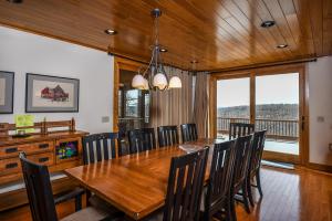 a dining room with a wooden table and chairs at Hawk Mountain in McHenry
